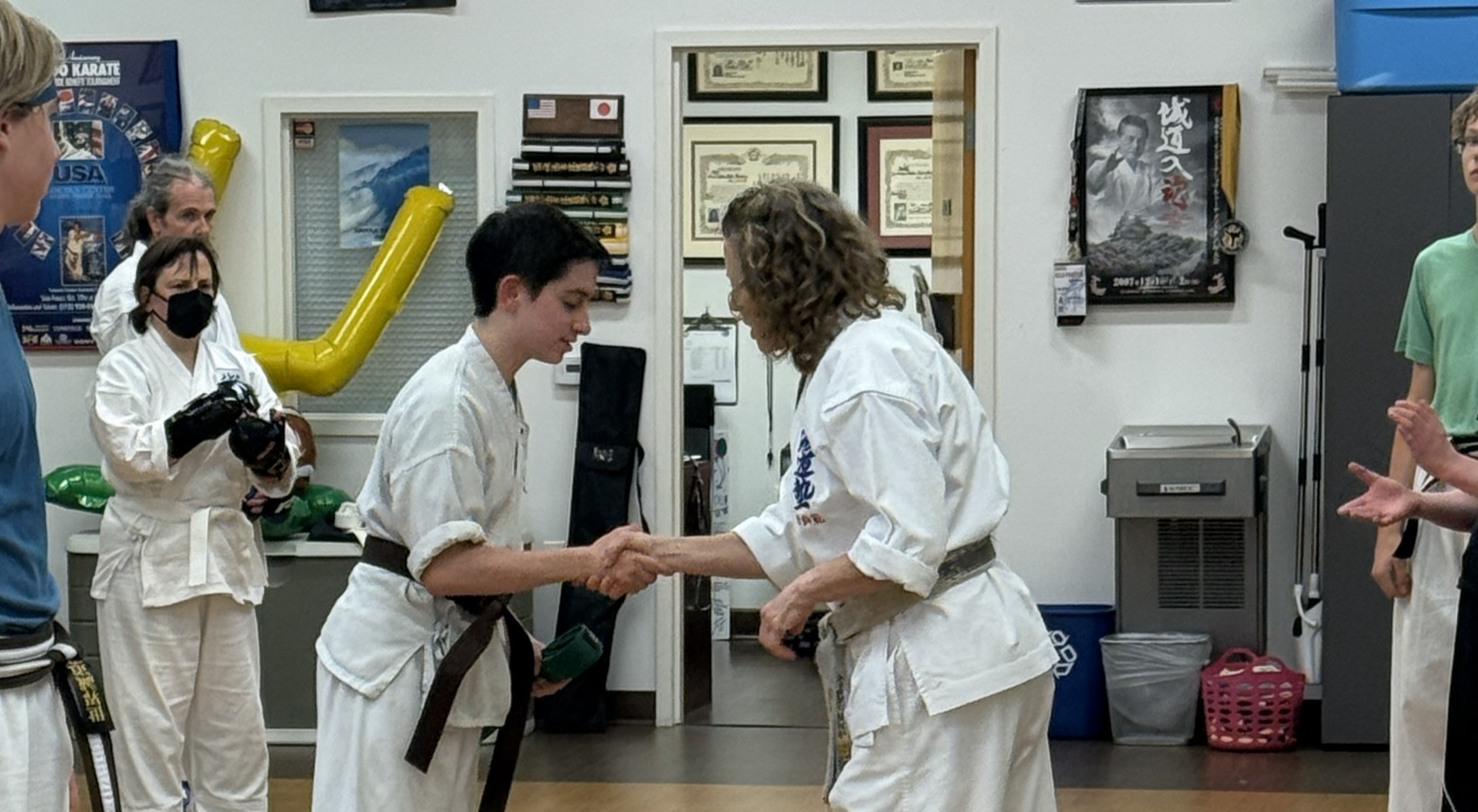A photo of me shaking hands with my instructor at our karate dojo